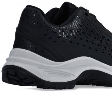 The image shows a black shoe with a modern design. The surface has a textured, glossy texture with triangular patterns. The sole is white and treaded.