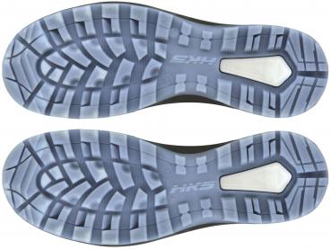 The image displays the underside of sports shoes. The sole features a textured tread with various grooves and patterns for improved grip. A prominent logo is located in the center.