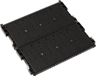 The image shows a black, flat plastic plate with several parallel grooves and recesses. It has fasteners at the corners and is rectangular in shape.