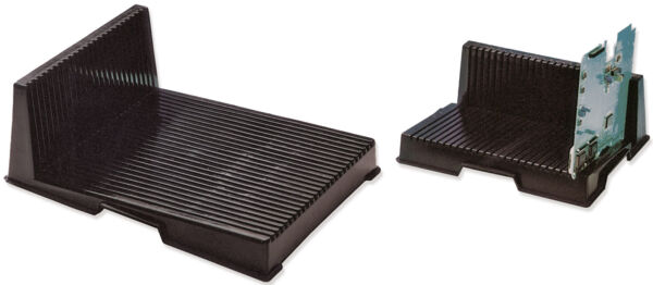 The image shows a black, rectangular holder with a slanted, green component. The holder has a textured surface and serves to support the component.