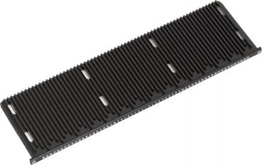 The image shows a black, elongated object with many parallel grooves. It has a smooth surface and device slots or openings at the edges.