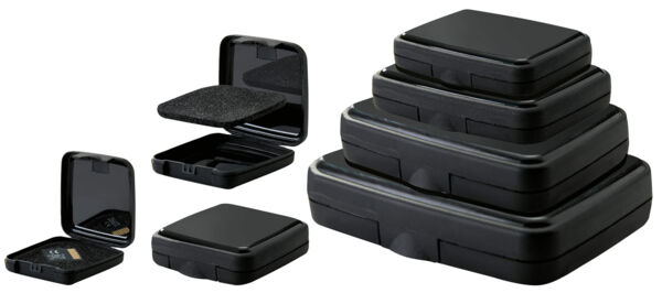 The image displays a flat, square, black object with rounded corners. The surface is slightly glossy, and there is a small notch on one side, presumably an opening or tab.