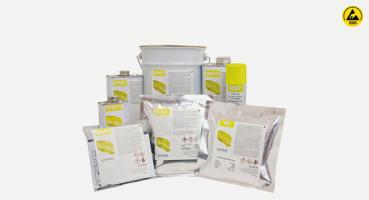 The image displays an arrangement of various containers with chemicals. These include cans, bags, and a bucket, all in different sizes, with labels that contain warning symbols and information.