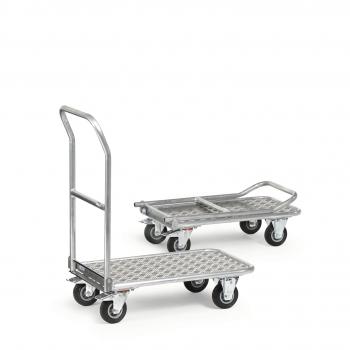 The image shows two metal transport carts. The front one has a long handle and a sturdy surface with metal mesh, which is less pronounced at the back. Both carts have rolling wheels.