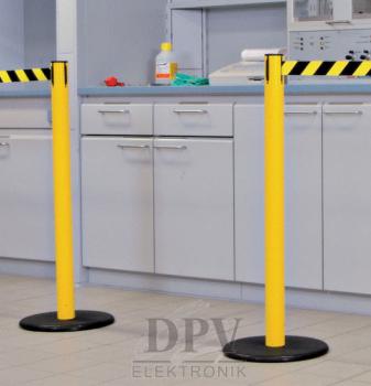 The image shows a red-orange post with a horizontal barrier. The barrier has red and white stripes. The post is mounted on a round black base.