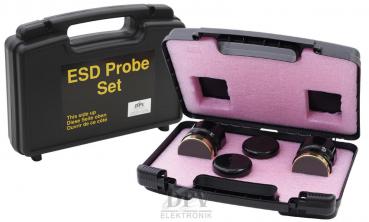The image shows a black suitcase with a pink interior. It contains three round, metallic-looking objects and has yellow lettering on the outside that reads 