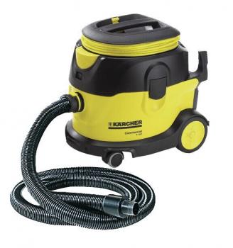 The image displays a sturdy, yellow and black vacuum cleaner with a large container on wheels. A flexible hose is attached to the side and has a smooth surface.