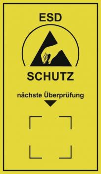 The image shows a yellow warning sign with a black symbol: a hand sign and a triangle. Below it reads "ESD PROTECTION" and "next inspection" in black letters.