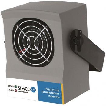 The image shows a rectangular, gray device with a round ventilation grille at the front. On the side, there is a rotary switch. Below, there is a colored sticker with model information.