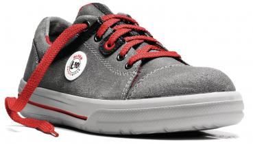 The image shows a gray suede shoe with red laces. On the side, there is a white logo. The sole is flat and white with a red accent.
