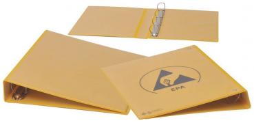 The image shows a yellow folder. It has a round metal mechanism for opening and closing. On the front, there is a symbol with a stylized arrow or a logo.