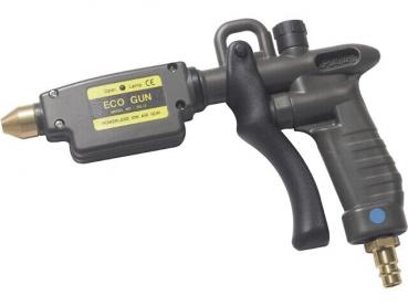 The image shows a black spray gun with a gray handle. It has a metal nozzle at the front and a yellow sticker labeled 