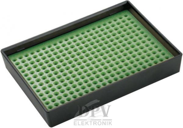 Das Bild zeigt eine rechteckige, flache Box mit einer grünen, genoppten Oberfläche. Die Noppen sind gleichmäßig verteilt und helfen bei der Befestigung von Objekten. Die Box hat einen schwarzen Rand.
