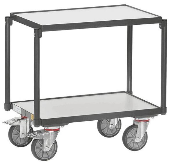 The picture shows a sturdy serving cart with two shelves. It has a black metal frame and four large, movable wheels for easy handling.