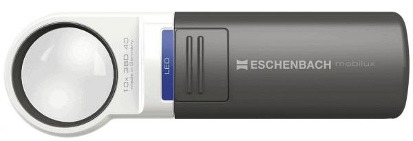 The image shows a handy reading device with a large, round glass lens and a gray, rectangular casing. On the top, there is a blue button and the inscription "ESCHENBACH".