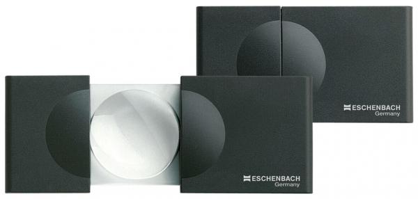 The image shows two black reading aids. A large, round lens is visible in the center, surrounded by two rectangular housings. They are compact and portable, ideal for reading.