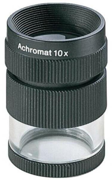 The image shows a black magnifying glass. The top has the inscription "Achromat 10x". The surface is ribbed for better grip, and the lower part is transparent.