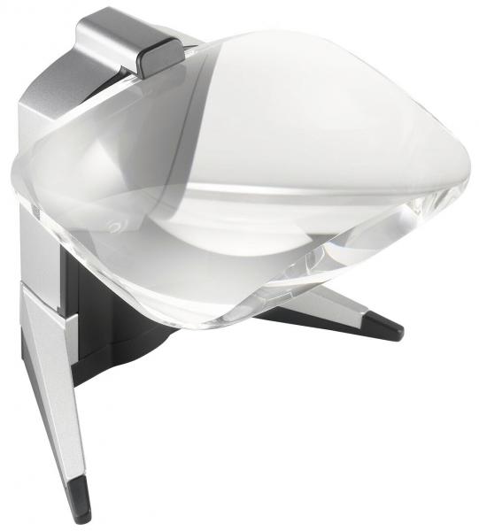 The image shows a modern magnifying glass with a transparent, curved glass. It is mounted on a sturdy, silver stand and has two black feet for stability.