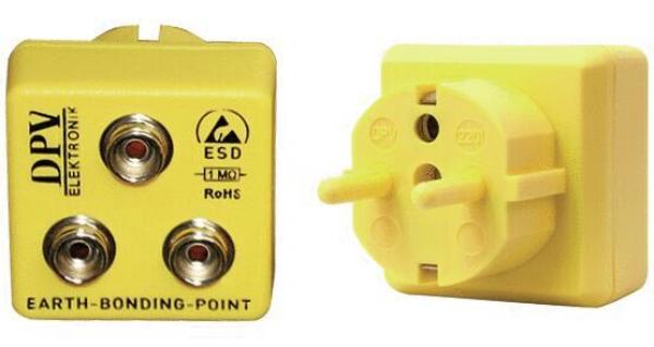 The image shows a yellow grounding connector with two round sockets and an additional outlet on the right side. It is used for the safe grounding of electrical devices.
