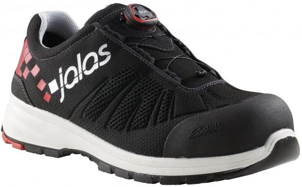The shoe is black with white and red accents. It features a sporty design, a non-slip sole, and a reinforced toe cap. Instead of laces, there is a simple twist-lock system.