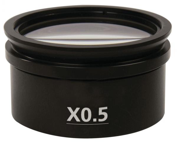 The image displays a black lens with a diameter of about 7 cm. On the front, it is labeled "X0.5". The lens is mounted on a round casing.