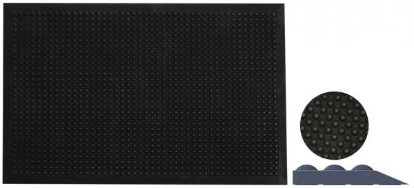 Das Bild zeigt eine große, schwarze Matte mit vielen kleinen Erhebungen in gleichmäßigem Muster. Daneben ist eine kleine runde Matte und ein dreieckiges Element zu sehen, ebenfalls in Schwarz.