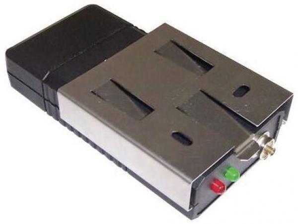 The image shows an electronic device with a black plastic casing and a silver metal front. On the front, there are two slots and two light indicators: one green and one red.