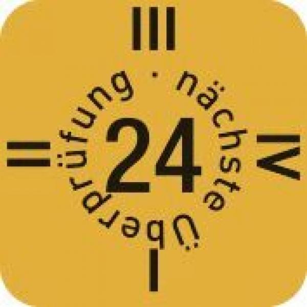 The image displays a yellow, square inspection mark. In the center is the number "24". Around the number, the words "next inspection" and "review" are arranged. There are lines at the corners.