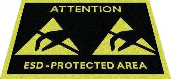 The image shows a sign on a black background with yellow triangles and the inscription "Attention ESD-Protected Area". It indicates an area that is protected against electrostatic discharge.