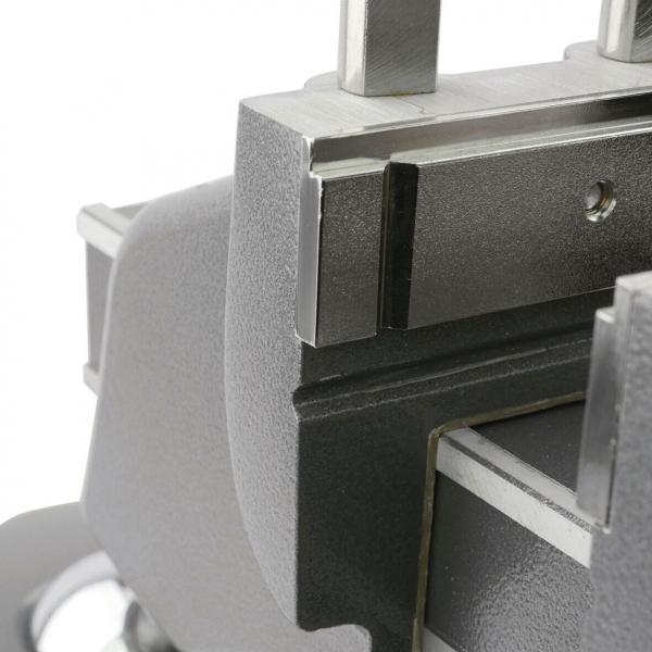 The image displays a section of a mechanical device, likely a precise mount. The surface is smooth and metallic, with sharp edges and textured areas.
