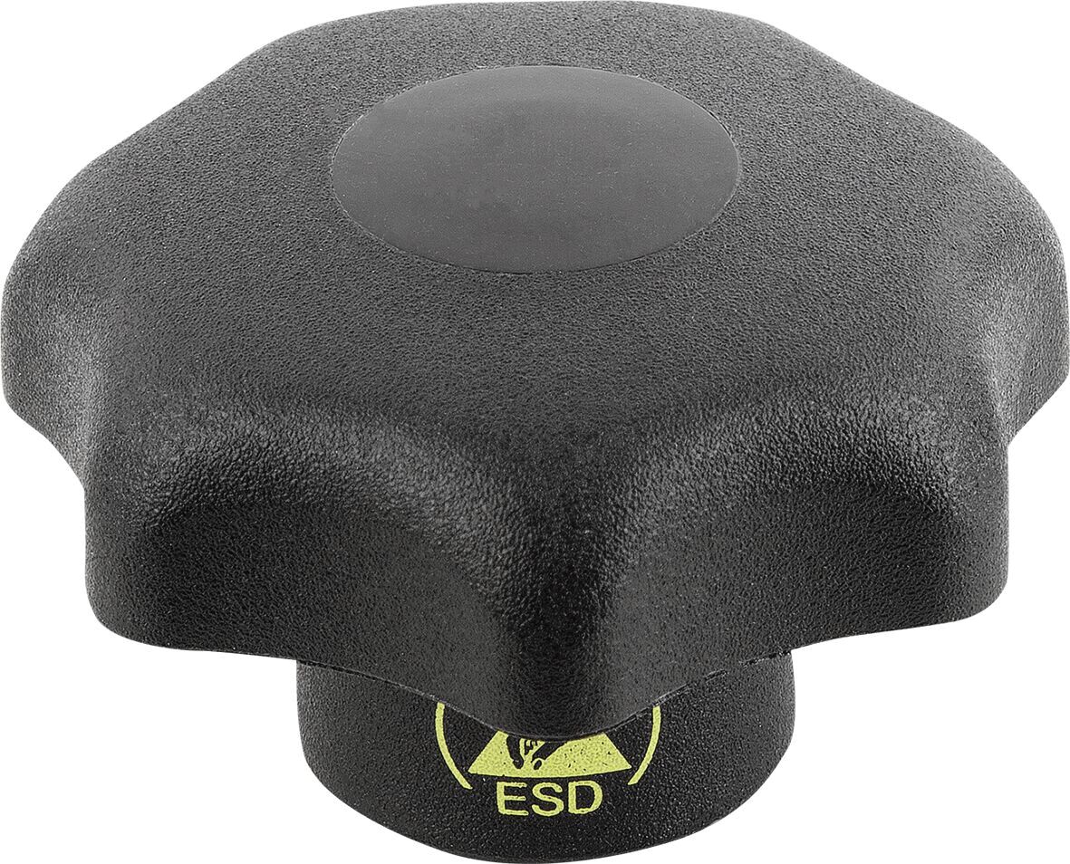 The image shows a black, eight-pointed button that is flat on top. In the center, there is a round, smooth surface. At the bottom, a yellow ESD symbol is visible.