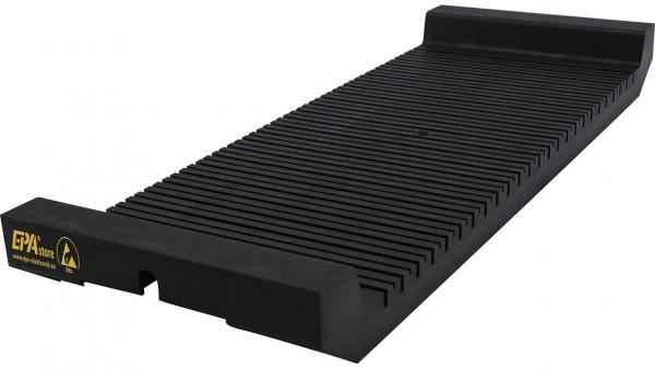 The image shows a long, narrow ramp piece made of black rubber. The surface has parallel grooves and a raised edge on one side. It likely serves as a driveway ramp.