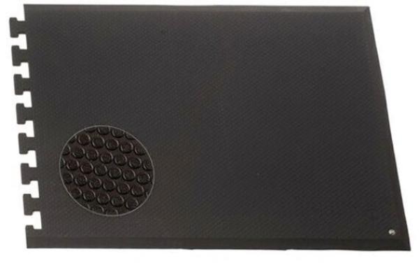 The image shows a black, rectangular mat. Part of it is covered with small round bumps. On the left side, there are cutouts intended for connecting with other mats.