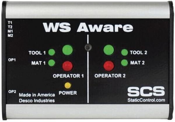 The image shows a rectangular device with a metal surface. It features green and red lights as well as labels for tools and mats. At the top, it reads "WS Aware" and at the bottom, the logo "SCS".