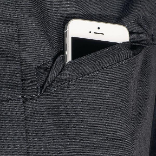 In the picture, a smartphone is visible in a dark pocket. Only the top part of the phone sticks out, and the screen is black. The pocket has a clear, simple seam.