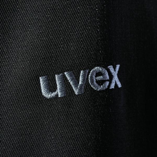 The image shows a black fabric with the "uvex" logo embroidered in light thread. The letters are clear and modern, with a slight texture.