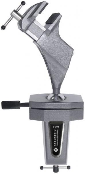 The image shows a sturdy metal table vise. It has a solid body with two clamping surfaces, which are pressed against each other with a screw.