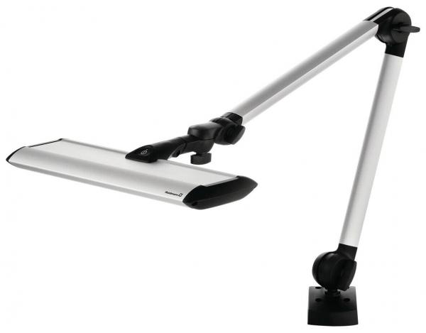 The image shows a modern desk lamp with a long, adjustable arm. The lampshade is flat and elongated, in silver color, attached to a sturdy base.