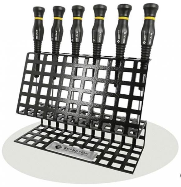 The image shows a black, grid-like holder with six screwdrivers. The screwdrivers have grippy, black handles with yellow accent lines, standing upright in the holder.