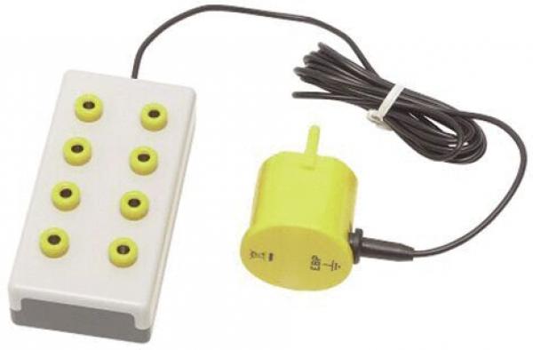The image shows a control unit with a rectangular white base and seven yellow buttons. A round yellow part with a power button is attached by a cable.