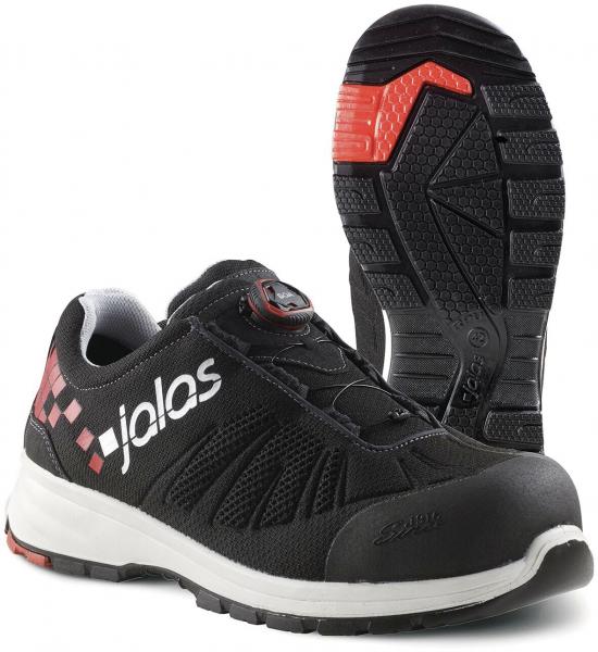 The image shows a black safety shoe with red accents. It features a sturdy rubber sole and reinforced toe protection. The laces are easy to use thanks to a special system.