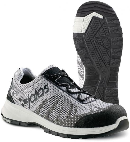 The image shows a gray sports or running shoe with black and white accents. The sole has a textured pattern for better grip. Laces are visible.
