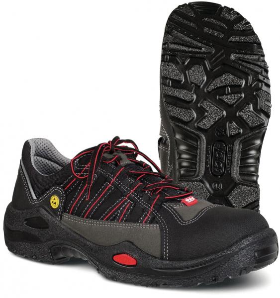 The image shows a black shoe with gray and red accents. It has laces and a non-slip rubber sole with good tread. The shoe is sporty, sturdy, and comfortable.