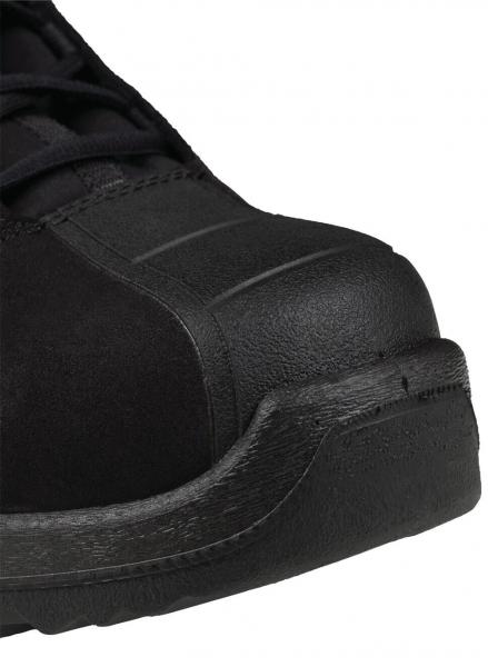 The image displays a black shoe made from a sturdy, slightly shiny material. The front has a rounded shape and a reinforced toe cap. The shoe is designed in a sporty style.