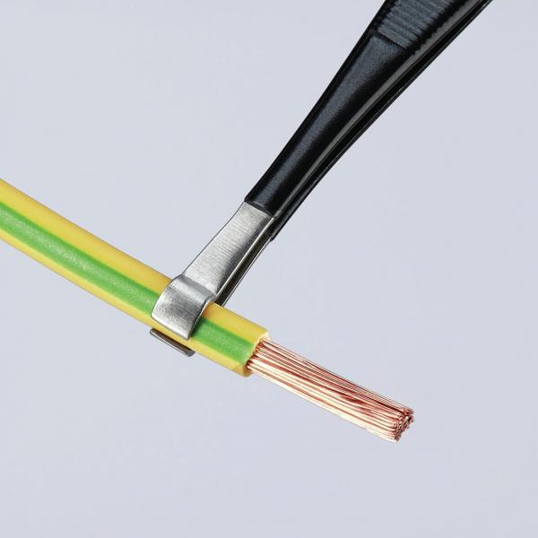 The image shows an exposed copper wire surrounded by a green and yellow insulation jacket. A pair of pliers holds the wire in place.