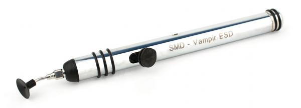 The image shows a silver SMD soldering iron with a rubberized handle. It has a pointed, metallic tip and a black rubber stopper. The body is labeled "SMD - Vampire ESD".