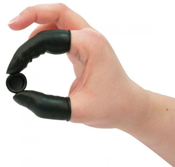 A hand with black, rubberized finger guards forms a circle. A small, round object is held between the thumb and index finger.