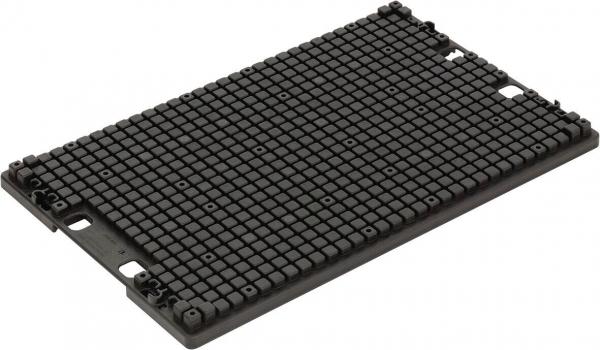 The image shows a rectangular, black plate with many small, uniform elevations. The surface is textured and has two recesses at the corners.