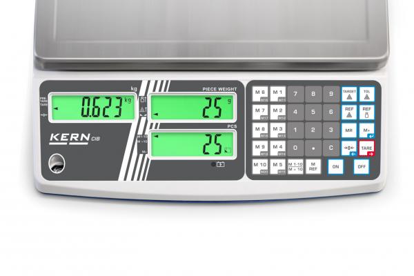 Das Bild zeigt eine digitale Waage mit grün leuchtendem Display. Links steht das Gewicht (0,623 kg), rechts sind Tasten für Einstellungen und das KERN-Logo ist sichtbar.