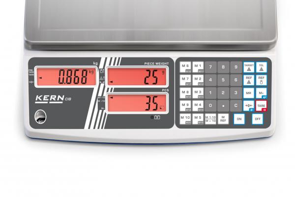 Das Bild zeigt eine digitale Waage mit mehreren roten Anzeigen für Gewichte und einer Tastatur. Die Marke "KERN" ist sichtbar. Es gibt Tasten zur Eingabe und Programmierung.